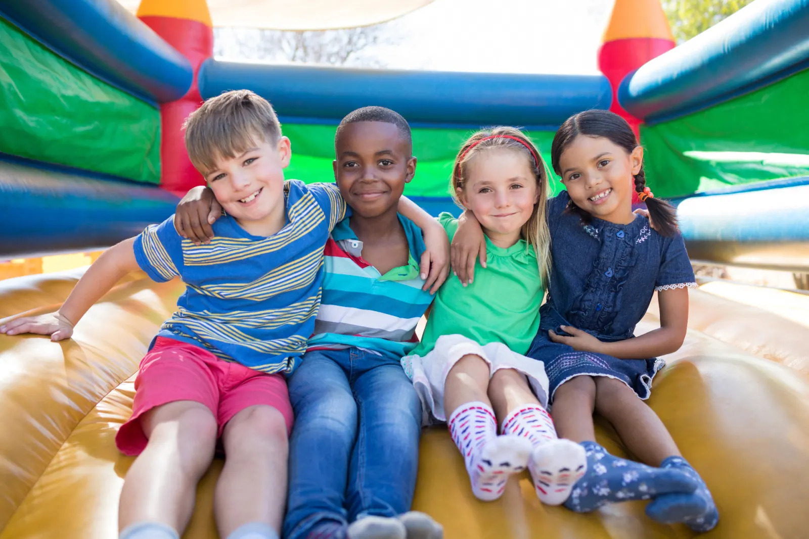 Group of kids having fun in a bounce house rental